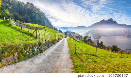 Exciting autumn view on suburb of Stansstad city and Lucerne lake with mountaines and fog Exciting autumn view on suburb of Stansstad city and Lucerne lake with mountaines and fog 106780167