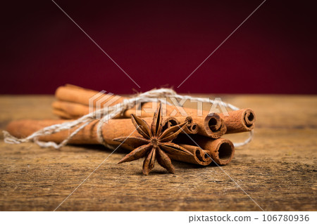 Close up of cinnamon sticks and star anise on wood 106780936