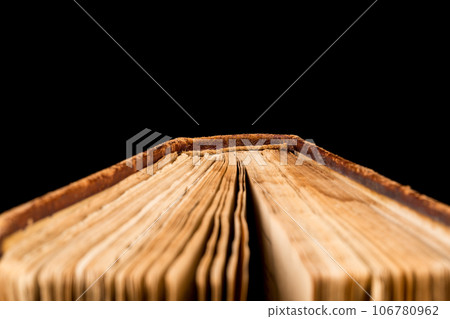 ancient book shot on black background ancient book shot on black background 106780962