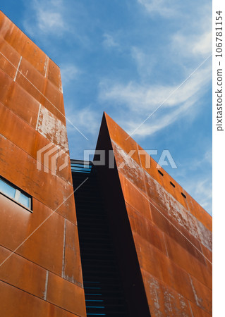 Facade of European Solidarity Centre building, Europejskie Centrum Solidarnosci in Gdansk Poland. Exterior on blue sky background. Monument to the fallen Shipyard Workers 1970 Old town. Museum Facade of European Solidarity Centre building, Europejskie Centrum Solidarnosci in Gdansk Poland. Exterior on blue sky background. Monument to the fallen Shipyard Workers 1970 Old town. Museum 106781154