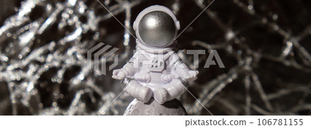 Plastic toy figure astronaut on silver background Copy space. Concept of out of earth travel, private spaceman commercial flights missions and Sustainability Plastic toy figure astronaut on silver background Copy space. Concept of out of earth travel, private spaceman commercial flights missions and Sustainability 106781155