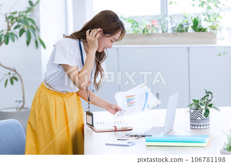 Business Young woman working on a computer Business Young woman working on a computer 106781198