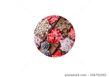 Christmas tree wooden toys in white and red colors, gingerbread and dried lemon and grapefruit slices Christmas tree wooden toys in white and red colors, gingerbread and dried lemon and grapefruit slices 106782093