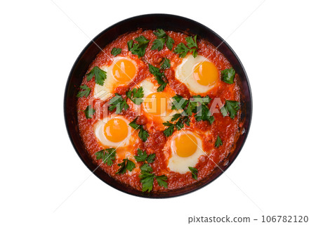Shakshuka, a dish with fried eggs with tomato sauce, sweet pepper, garlic, onions, spices and herbs 106782120
