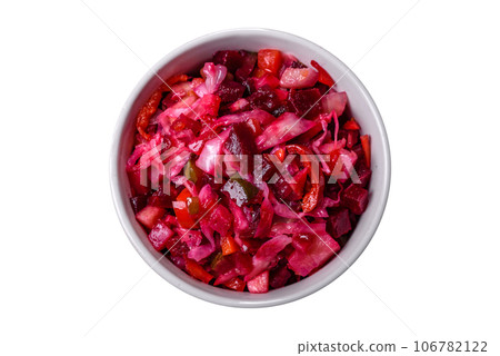 Traditional ukrainian beetroot salad vinaigrette on a white plate on a black concrete or slate background Traditional ukrainian beetroot salad vinaigrette on a white plate on a black concrete or slate background 106782122