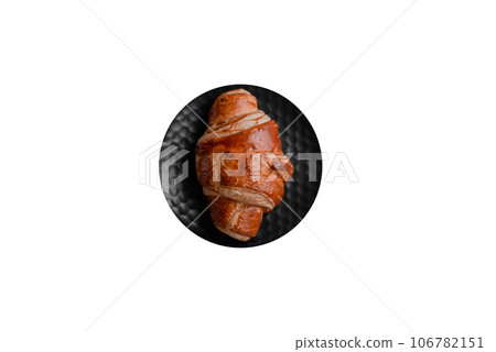 Delicious crispy croissant with chocolate with a cup of invigorating coffee 106782151