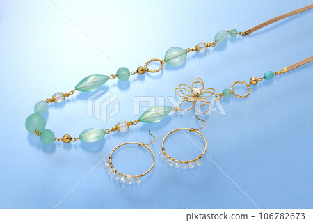 Colorful stone necklace and earrings with blue background Stylish earrings and stone necklace 106782673