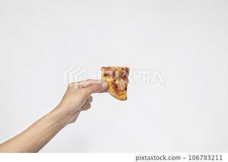 A human hand holding a slice of pizza A human hand holding a slice of pizza 106783211