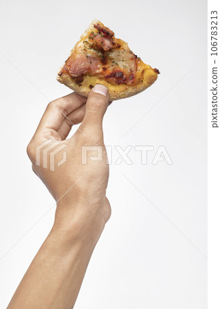 A human hand holding a slice of pizza A human hand holding a slice of pizza 106783213