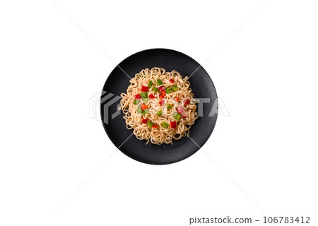 Delicious fresh noodles with sweet pepper, tomato, spices and herbs 106783412