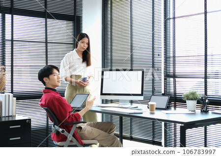 Male and female interior designers brainstorming and planning construction project together at creative office Male and female interior designers brainstorming and planning construction project together at creative office 106783997