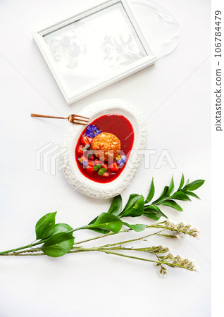 Fried ice cream in strawberry sauce with berries. Top view on white table 106784479