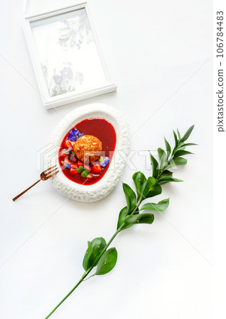 Fried ice cream in strawberry sauce with berries. Top view on white table 106784483