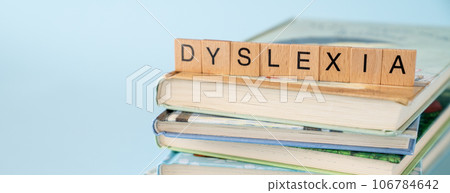 Dyslexia concept - name of disorder on books, blue background 106784642