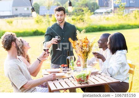 Multiracial Millennial Friends Raise Glasses in Toast Multiracial Millennial Friends Raise Glasses in Toast 106785150