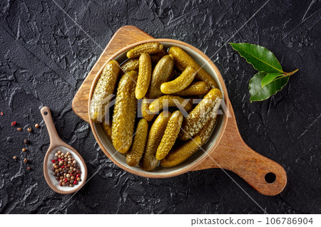 Pickled cucumbers with pepper and bay leaf. Fermented food 106786904