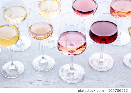 Wine glasses at a tasting. Rose, red, and white wines, drinks on a table 106786912