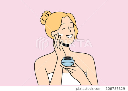 Woman applies anti-aging cream to face to stay beautiful, standing in bath towel after shower. 106787829