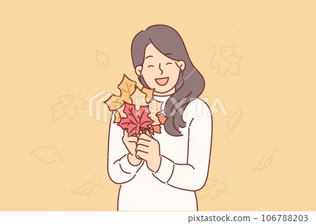 Woman holds autumn foliage of different colors in hands, collecting tree leaves to create herbarium 106788203