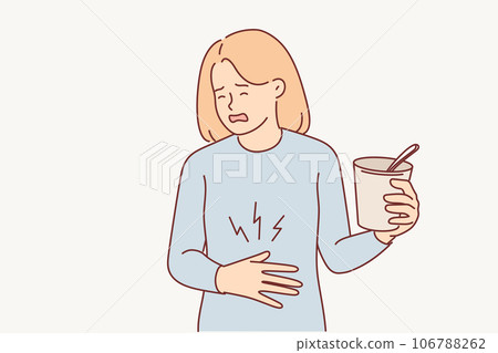 Woman suffers from heartburn and puts hand on stomach, holding glass of ice cream or instant soup 106788262