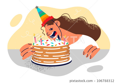 Little girl in birthday hat blows out candles on cake and greedily bites festive dessert Little girl in birthday hat blows out candles on cake and greedily bites festive dessert 106788312
