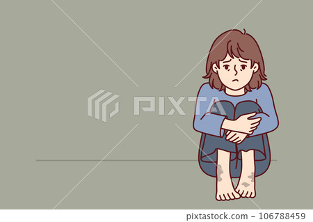 Sad poor girl with dirty feet sits on floor and is sad because of lack of home and money for food 106788459