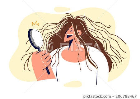 Shaggy woman is holding comb and laughing, seeing electrified hair sticking out in directions 106788467