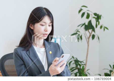 Female lawyer using smartphone 106789004