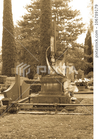 Stone crosses and tombstones in a cemetery. Black and white toned Stone crosses and tombstones in a cemetery. Black and white toned 106789179