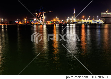 View of Lanterna (lighthouse) in the old port of the city of Genoa at night, Italy 106789201