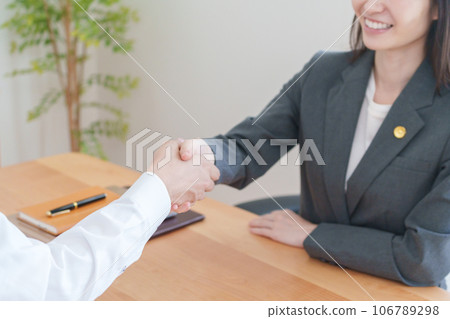 Client and female lawyer shaking hands Client and female lawyer shaking hands 106789298