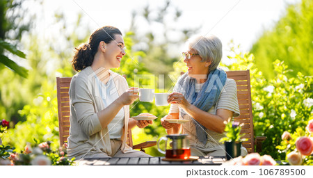 women drinking tea in the garden women drinking tea in the garden 106789500