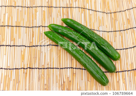 Several cucumbers placed on a bamboo blind Several cucumbers placed on a bamboo blind 106789664