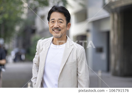 A man in his mid-50s smiling at the camera 106791576
