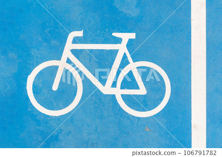 Blue bike symbol on blue road . Bikeway photo. 106791782