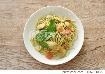 pesto spicy stir fried spaghetti with slice sausage and basil sauce on plate pesto spicy stir fried spaghetti with slice sausage and basil sauce on plate 106791838