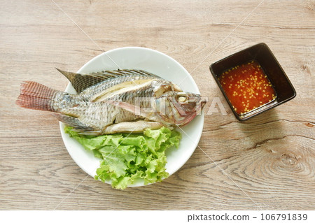 steamed mango fish with lettuce dipping spicy sauce on plate  106791839