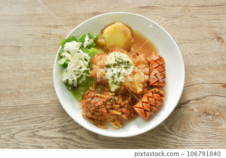 crispy fried chicken meat stuffed cheese with mash potato dressing gravy sauce and spaghetti and cabbage cos lettuce salad couple sausage on plate  106791840