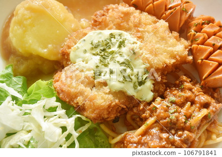 crispy fried chicken meat stuffed cheese with mash potato dressing gravy sauce and spaghetti and cabbage cos lettuce salad couple sausage on plate crispy fried chicken meat stuffed cheese with mash potato dressing gravy sauce and spaghetti and cabbage cos lettuce salad couple sausage on plate 106791841