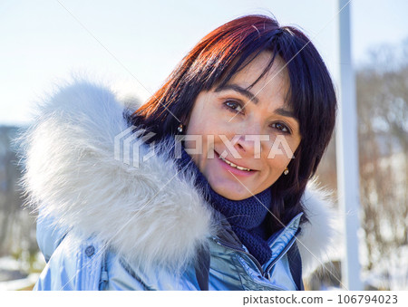 Forty five year old Russian woman sincerely, naturally and kindly smiling, looking at the camera 106794023