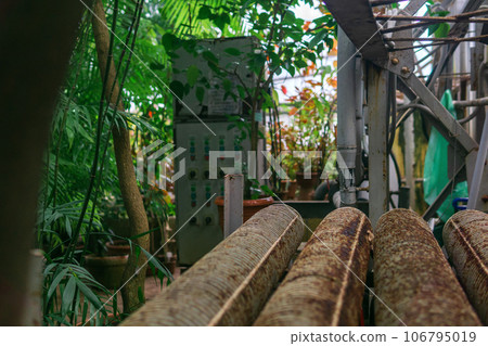 heating equipment in a large old greenhouse 106795019