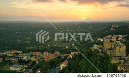 drone view, the sun sets behind the mountain landscape during a beautiful sunset with rays of sunlight drone view, the sun sets behind the mountain landscape during a beautiful sunset with rays of sunlight 106795068