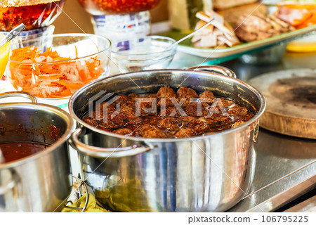 meatballs in asian sauce in a pot on street food in Vietnam meatballs in asian sauce in a pot on street food in Vietnam 106795225