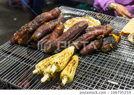 Grilled sweet potato and corn in vietnamese night market in Da Lat 106795259
