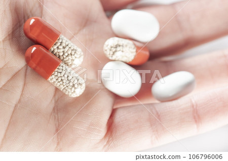 capsules and pills on palm of a hand capsules and pills on palm of a hand 106796006