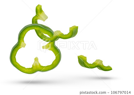 Set of green paprika cloves on a white isolated background close-up. Paprika of different sizes fall, casting a shadow, for insertion into a design or project 106797014