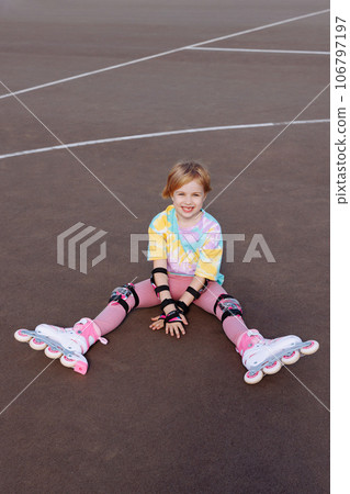 A beautiful little girl learns to roller skate A beautiful little girl learns to roller skate 106797197