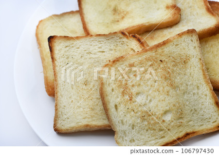 Fried toast on a white plate. Baked bread for sandwiches. Vegan food. 106797430