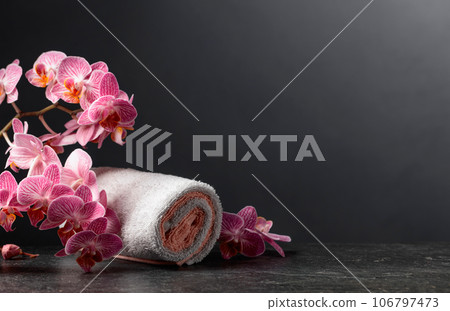 Beautiful blooming orchid flowers with towels. Beautiful blooming orchid flowers with towels. 106797473
