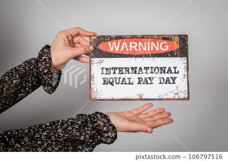 International Equal Pay Day 18 September. Warning sign with text on a white background 106797516